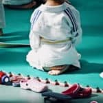 Ein Kind sitzt im Fersensitz im Judogewand